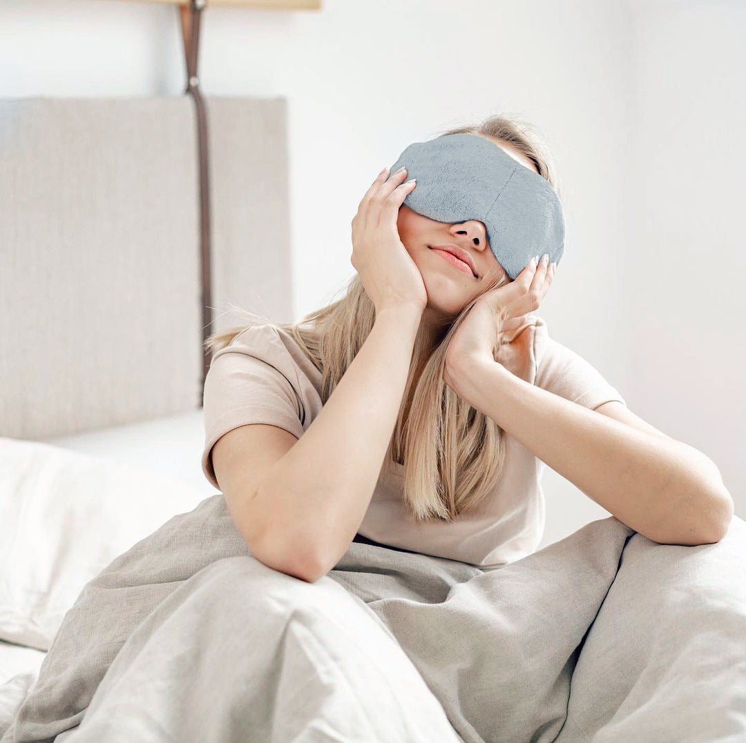 Relaxing with a grey weighted sleep mask